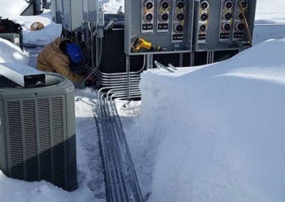 Working on electrical panels in the snow